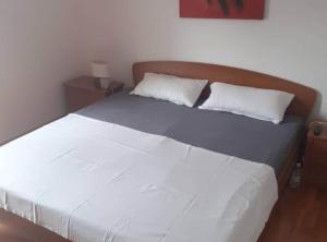 a bed with white sheets and pillows in a bedroom at Villa Ivan Vodice in Vodice