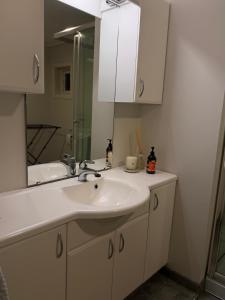 a bathroom with a sink and a mirror at Koselig hus i Beisfjord in Narvik +19 photos