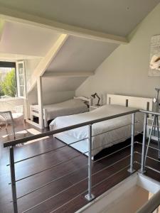 a bedroom with a bed and a glass table at Le Poule House in Guérard