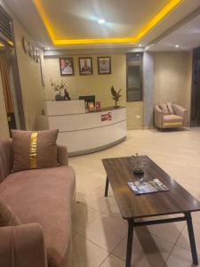 a living room with a couch and a coffee table at Spark Africa Hotel in Jinja