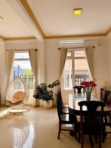 a living room with a dining room table and chairs at Tuong Vy Private Villa in Da Lat