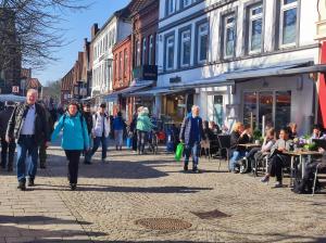 a group of people walking down a street at Ferienwohnungen am Schwanensee in Plön