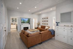 a living room with a couch and a fireplace at North Hamptons Retreat in Bundaberg