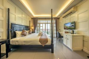 a hotel room with a bed and a desk and a desk at WUA LAI Boutique Hotel Chiang Mai in Chiang Mai