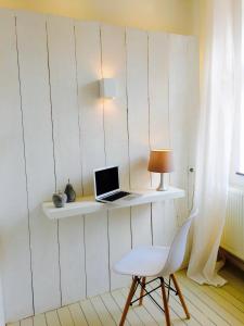 a laptop computer sitting on a white shelf on a wall at Apartment in Historical Center in Liège