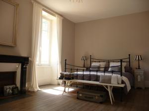 a bedroom with a bed and a fireplace at Domaine de Savigny in Saint-Saulge