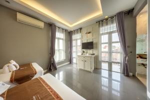 a hotel room with two beds and a television at WUA LAI Boutique Hotel Chiang Mai in Chiang Mai