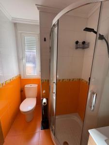 a bathroom with a toilet and a glass shower at Las Candelas, Casa Turística in Uruñuela +26 photos