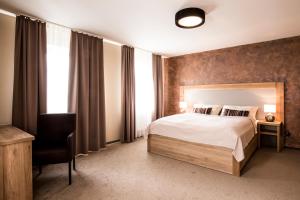 Postel nebo postele na pokoji v ubytování Penzion v Zálesí