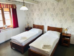two twin beds in a room with a window at Penzión Grobský Dvor in Slovenský Grob +33 photos