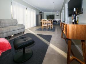 a living room with a couch and a table at The French River Chalets in Kalgan