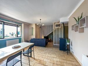 a living room with a table and chairs and a couch at Chez La Mamie in Saint-Jean-de Niost