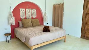 a bedroom with a bed with a teddy bear on it at Samma Villas - Onyx Villa - 1 BDR & Private Pool in Ko Phangan +21 photos