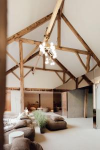 a room with many beds and a ceiling with beams at Hotel Château Palacio in Fauvillers +72 photos