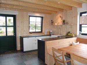 a kitchen with wooden walls and a wooden table at Ferienhaus am Nationalpark in Morsbach
