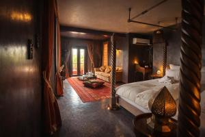 a bedroom with a bed and a living room at Jnan Lotf Marrakech - Le Jardin de la Bienveillance in Marrakesh +118 photos