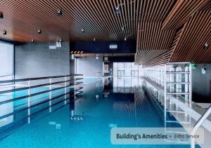 a swimming pool with blue water in a building at PentStudio Westlake - Cozy Duplex - New Apartment in Hanoi