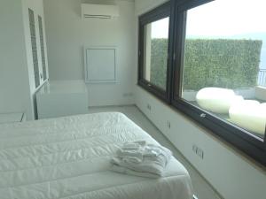 a bedroom with a bed and a large window at Reggio Suite in Reggio Calabria +54 photos
