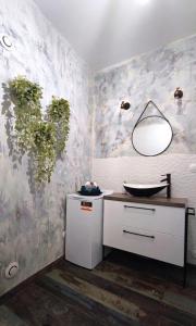 a bathroom with a sink and a plant on the wall at Cocon cosy hyper-centre idéal 4 personnes in Tours +20 photos