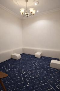 a meeting room with two chairs and a chandelier at Smo Hail سمو حائل in Hail +7 photos