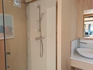 a bathroom with a shower and a sink at Tiny house Oléroncoast La-Brée-Les-Bains in La Brée-les-Bains +16 photos