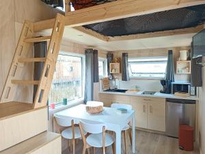 a small kitchen with a table and chairs in a tiny house at Tiny house Oléroncoast La-Brée-Les-Bains in La Brée-les-Bains