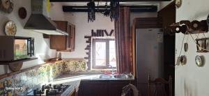a kitchen with a sink and a window at Casa rural las conchas in Cazalla de la Sierra +5 photos