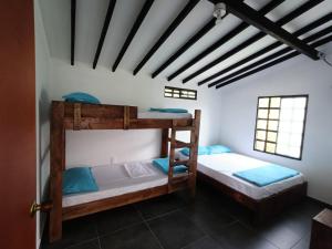 a bedroom with two bunk beds in a house at Shaddai Villeta Centro Ecoturistico in Villeta +136 photos