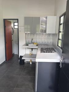 a kitchen with a sink and a stove in it at Shaddai Villeta Centro Ecoturistico in Villeta