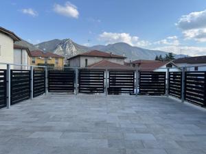 a parking lot with a fence and mountains in the background at EDEL Vacation Home in Terni
