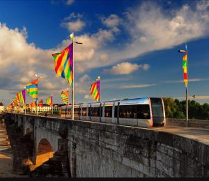 a train on a bridge with flags and flags at Cocon cosy hyper-centre idéal 4 personnes in Tours