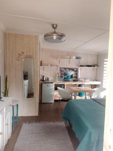 a kitchen and a living room with a table in a room at Avalon Cottages in Barberton +13 photos