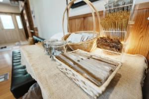 a table with a basket and other items on it at Hostel SAMURISE NORTH in Fujikawaguchiko +45 photos