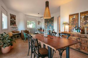 a dining room with a wooden table and chairs at Villa Maravilla in Lloret de Mar