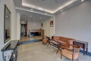 a living room with a couch and a table at Hotel Dreamland in Pune