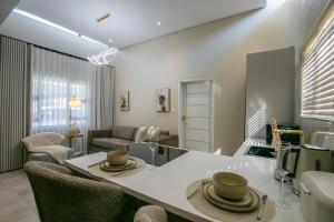 a kitchen and living room with a table and chairs at Ditsametse Luxe Suites in Gaborone