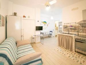 a kitchen with a refrigerator and a table in a room at Casetta Milu’ in Ustica