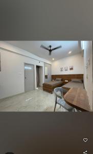 a living room with a ceiling fan and a table at Sanvi studio rooms in Bangalore