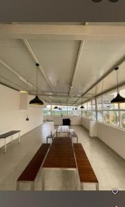 a large room with benches and tables in it at Sanvi studio rooms in Bangalore