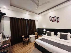 a hotel room with a bed and a window at Banj View Resort in Mussoorie