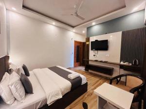 a hotel room with a bed and a desk and a television at Banj View Resort in Mussoorie