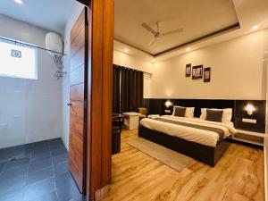 a hotel room with two beds and a bathroom at Banj View Resort in Mussoorie +9 photos