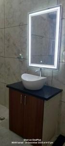 a bathroom with a sink and a mirror on a counter at aasara resort in Bhopal