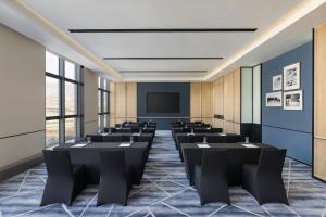 a conference room with chairs and a projection screen at Four Points by Sheraton Tianshui in Tianshui