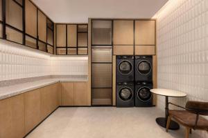 a laundry room with two washer and dryer at Four Points by Sheraton Tianshui in Tianshui