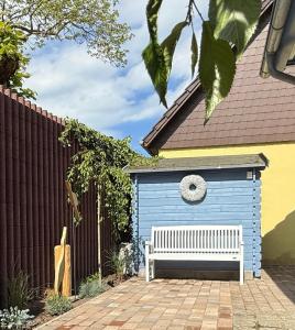 a blue shed with a bench in front of it at Sommerbrise in Zingst