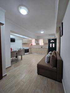 a large living room with a couch and a kitchen at Dimitris House Petriti in Petrití