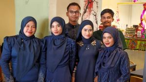 a group of muslim people posing for a picture at Amazing Rooms in Semporna