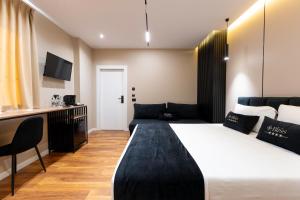a hotel room with a large bed and a couch at Bliss Boutique Hotel in Durrës