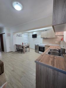 a kitchen with a sink and a table in a room at Dimitris House Petriti in Petrití +12 photos